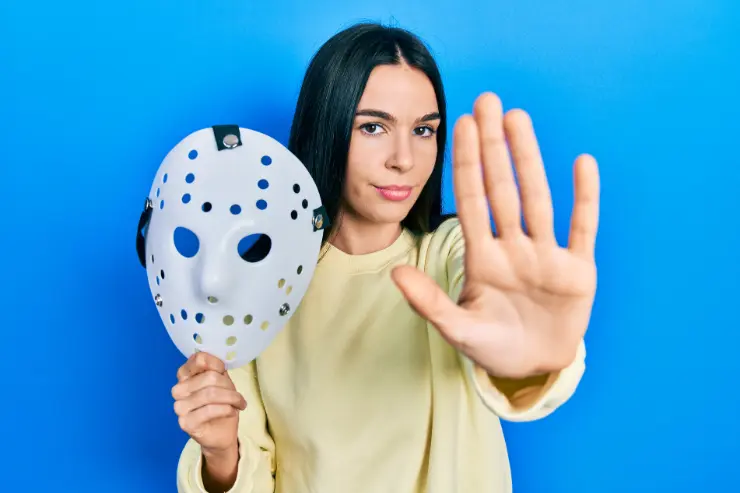 woman holding a hockey mask