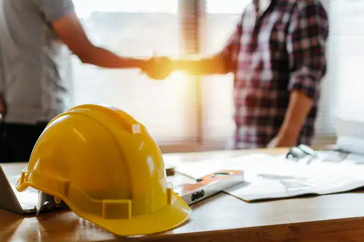 worker planning repairs with homeowner